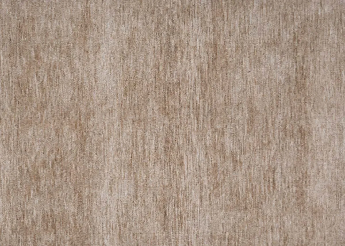 A close up view of the rugs sandy beige surface highlighting the soft textured weave with subtle vertical lines.