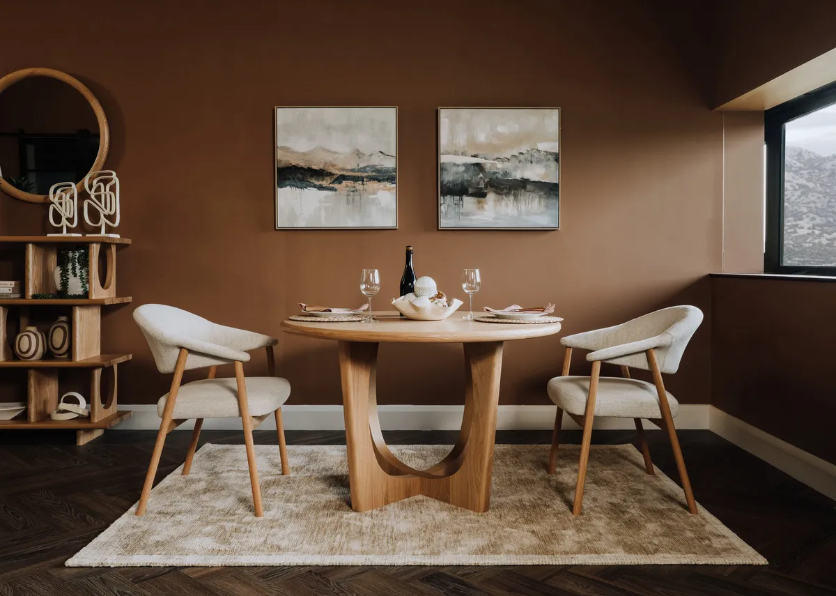 A lifestyle image of the Elk dining chair with Flow dining table and Menlo rug.