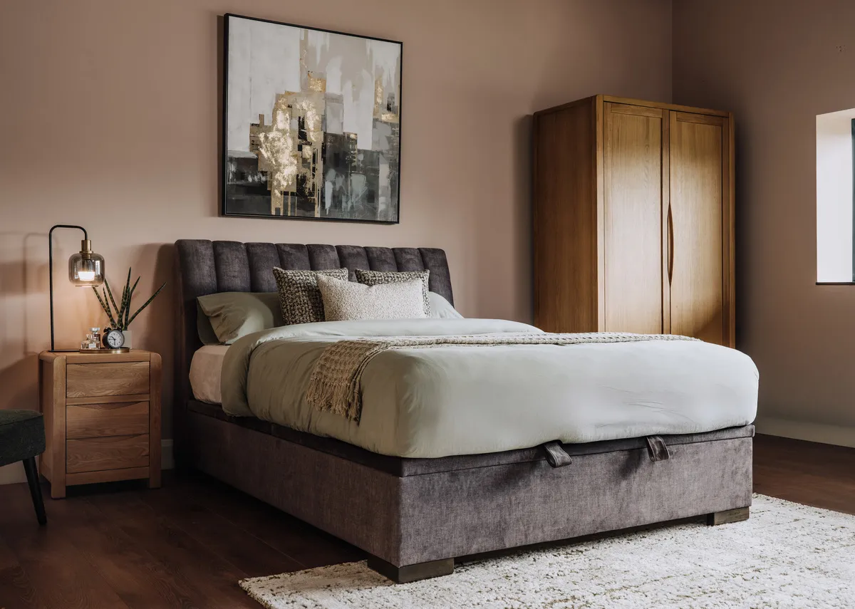 A lifetsyle image of the Moray rug with the Lancelot ottoman and iris wardrobe and locker