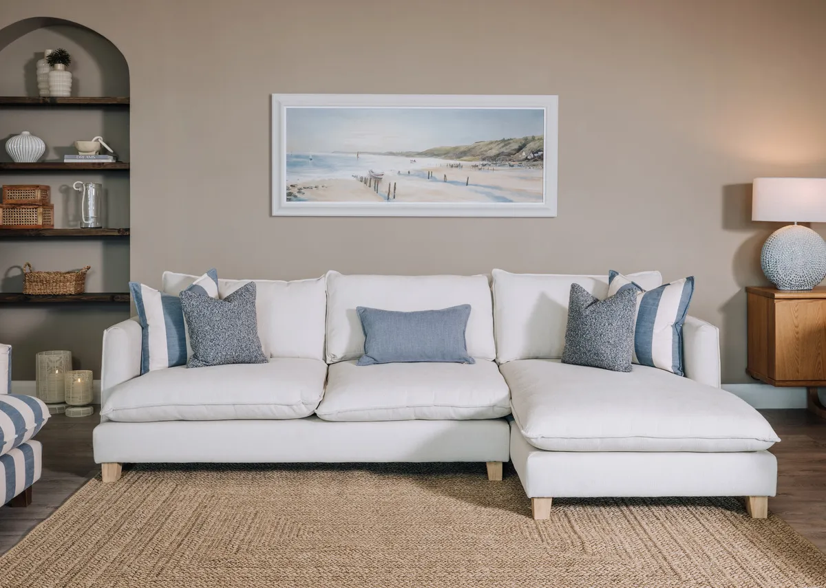 A lifestyle image of the Howth corner sofa with the Kenzy stripe rug.