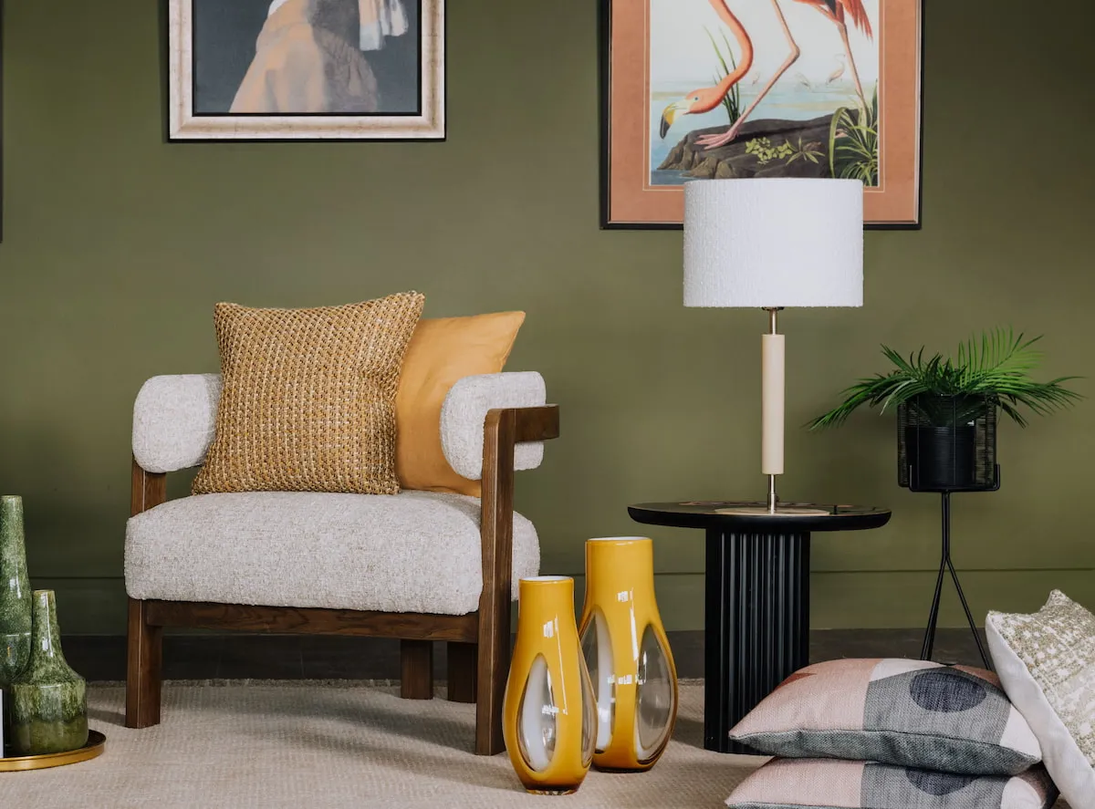 A lifestyle image of the Noma occasion chair with side table with Kulai lamp and Caseros vases.