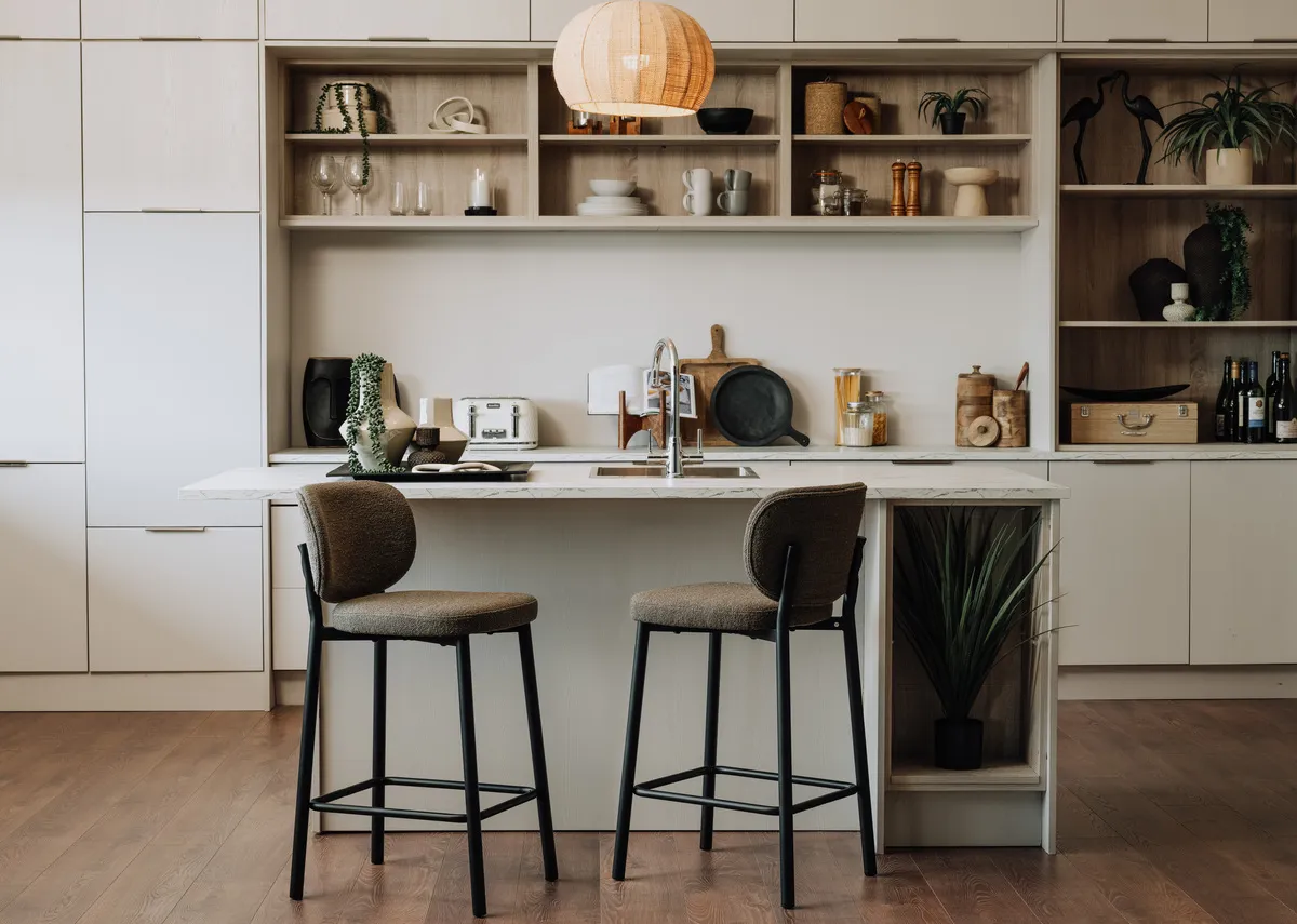 A lifetsyle image of 2 Swan taupe bar stools at a kitchen island.