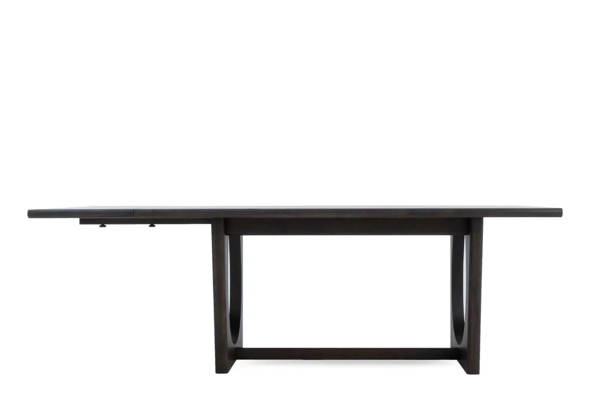 A dark brown oak dining table from EZ Livings Flow range.Front view of table with extension leaf