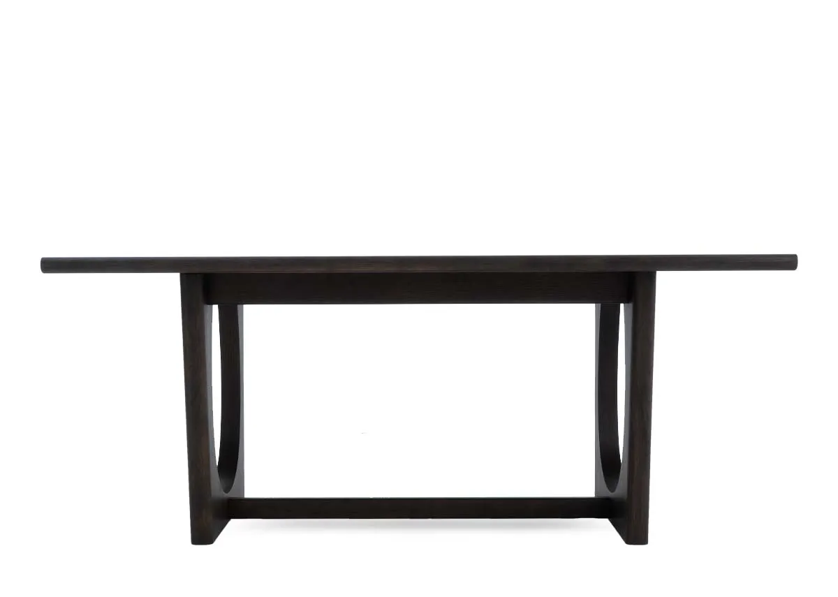 A dark brown oak dining table from EZ Livings Flow range.Front view of table with no extension