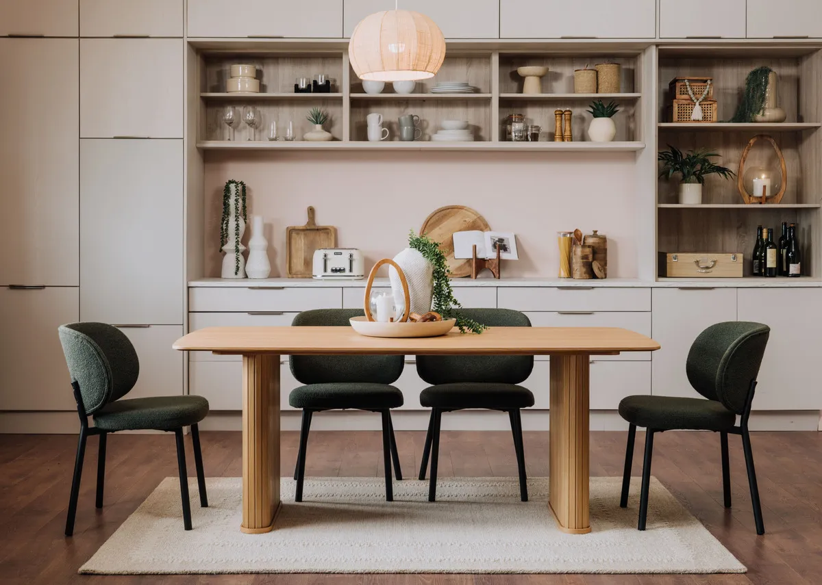 A lifetsyle image of the Nola natural dining table with Swan chairs