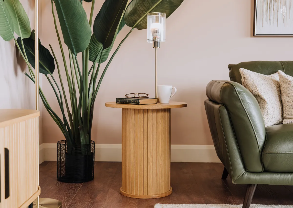 A lifetsyle image of the Nola natural oak lamp table with the Toscana sofa with Karina lamp.