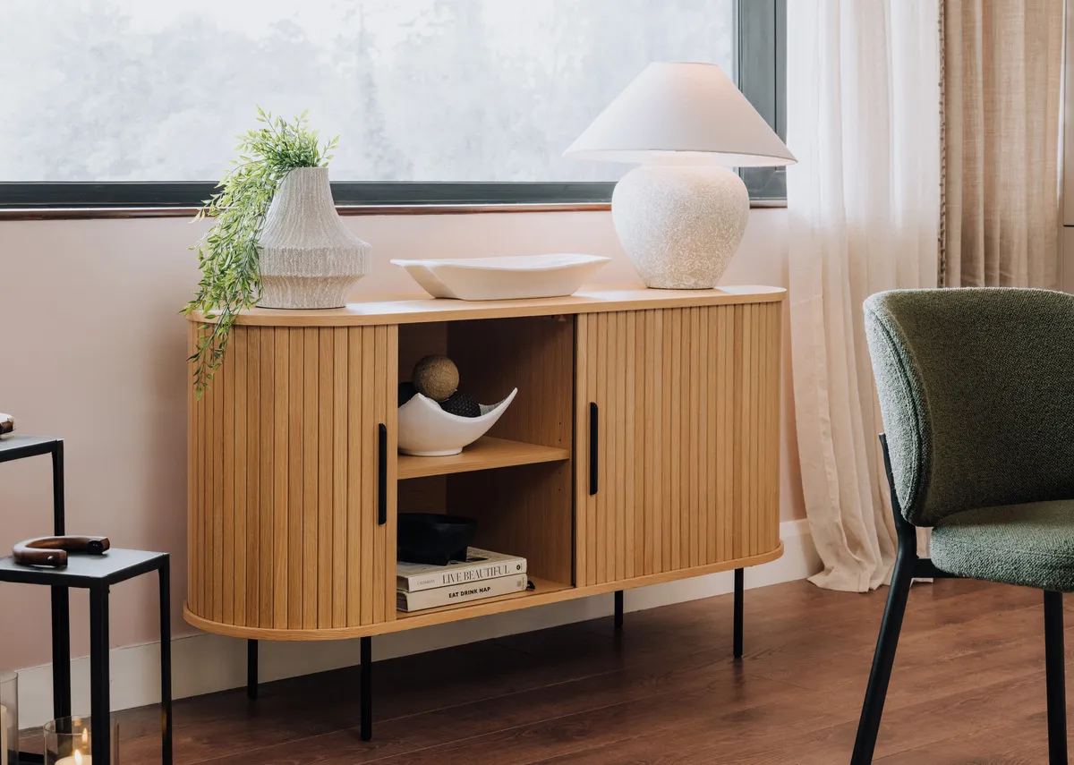 A lifestyle image of the sideboard open showing hidden storage.