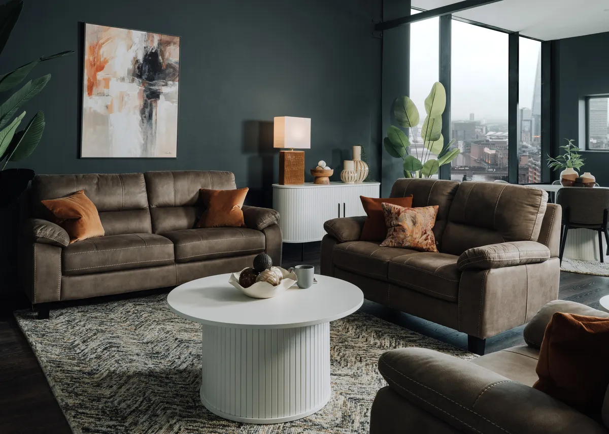 A lifetsyle image of the Nikita sofa range with Nola white coffee table and sidenoard with Dee lamp.