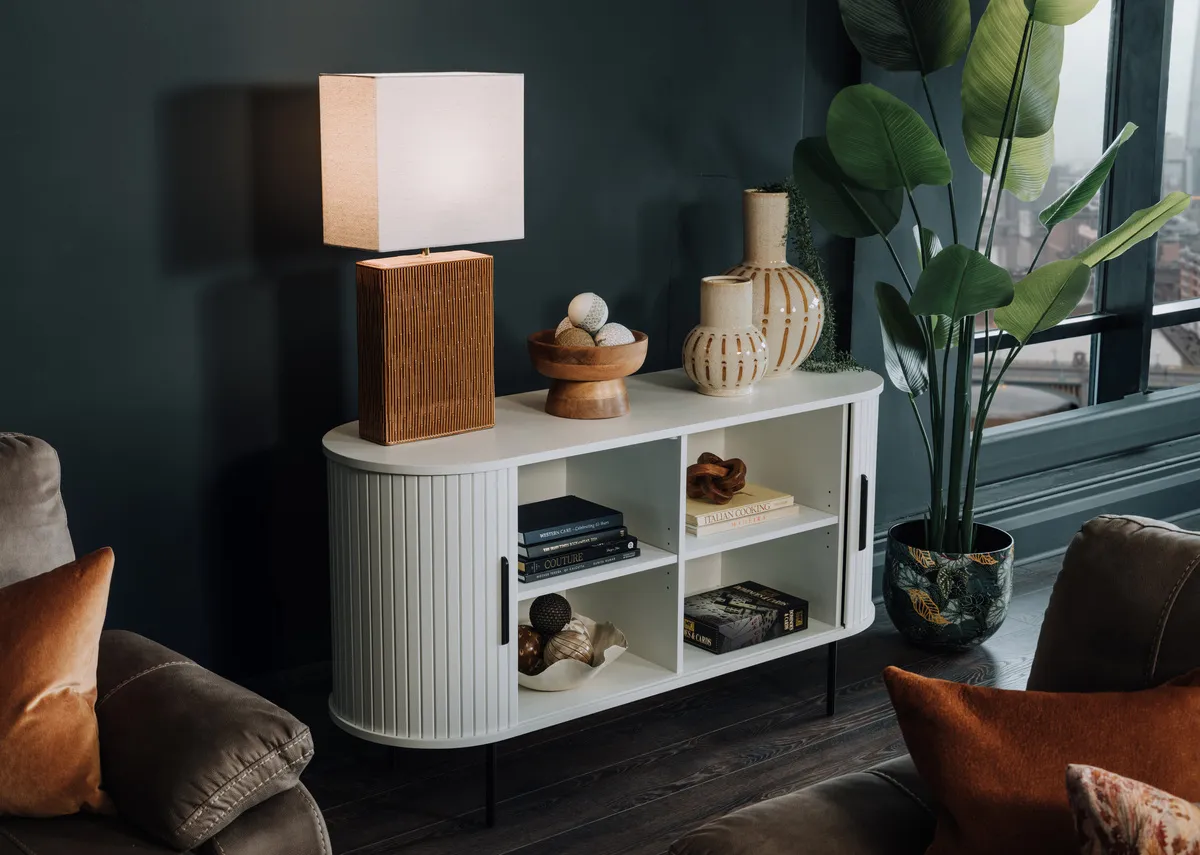 A lifestyle image of the Nola white sideboard open to show shelving space