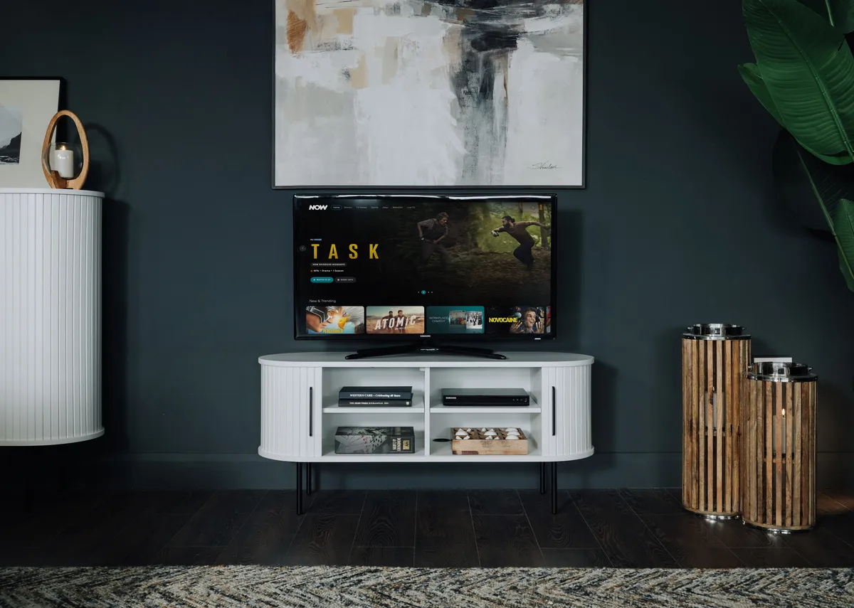 A lifestyle image of the Nola white tv unit with doors open and Integrity canvas.