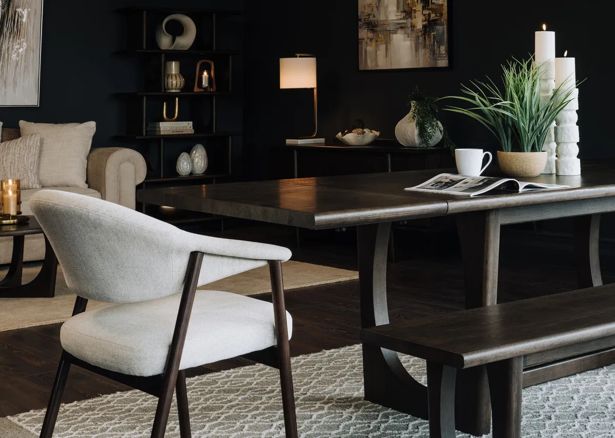 A lifestyle image of the Flow Dining table with extension leaf and elk dining chairs