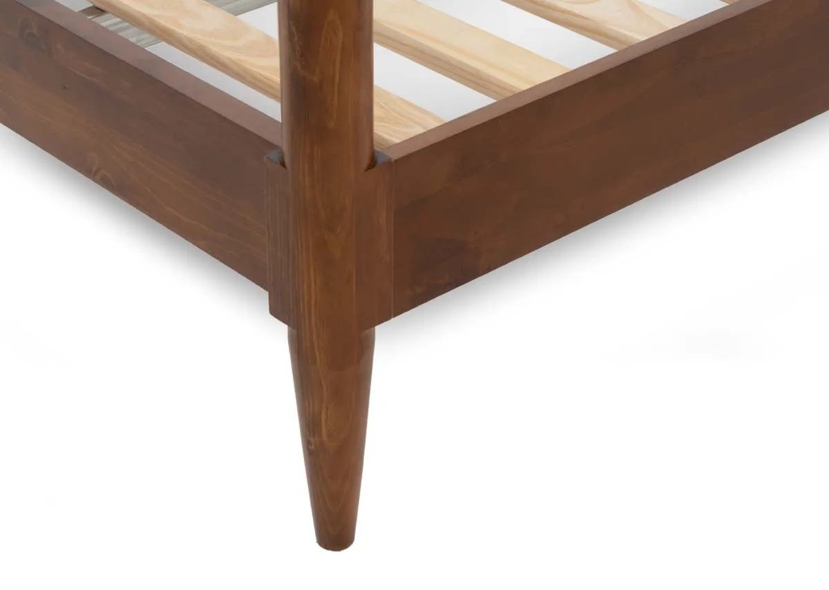 A close up view of the wooden bed frames tapered leg and corner showing the sturdy wooden slats that support the mattress.