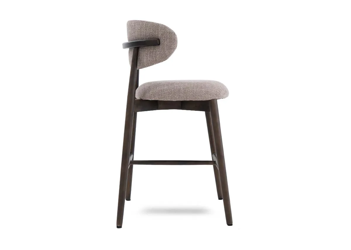A beige fabric counter bar stool with drown wood frame from EZ Livings Hazel range. Side view