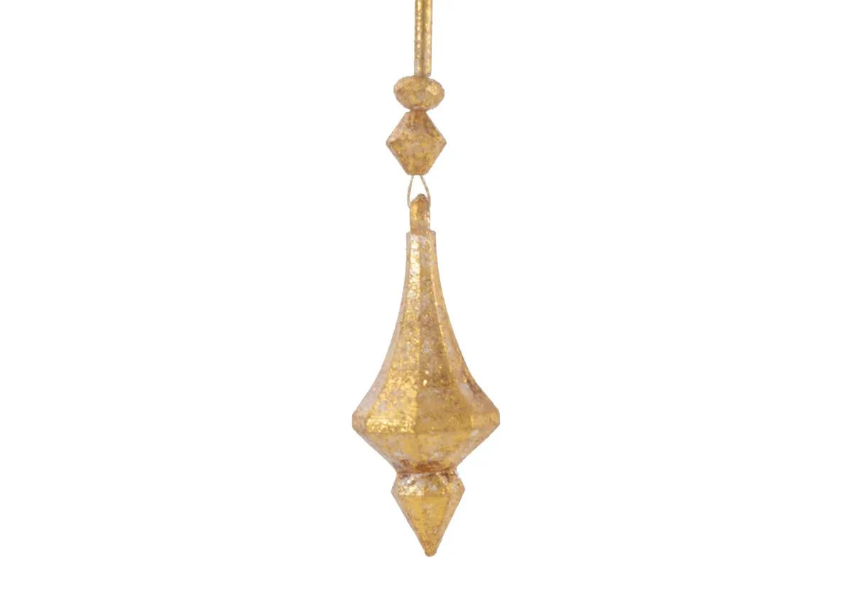 A close up of the faceted diamond shaped finial and some spherical beads on a gold diamond garland showing its texture.