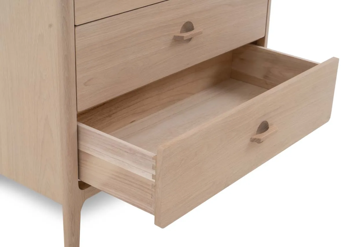 A white oak chest of 3 large and 2 small drawers from EZ Livings Jay range.Closeup of drawer open