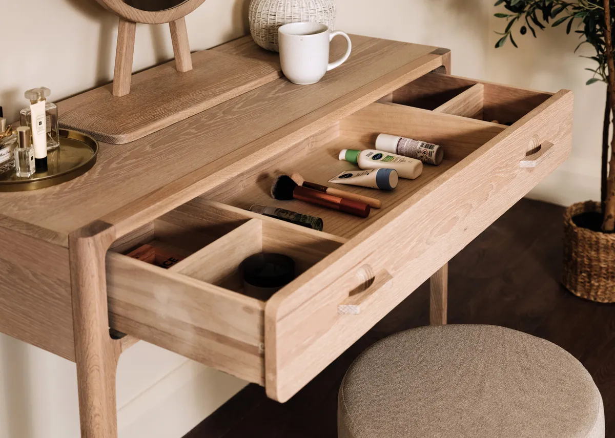 A lifestyle image of the Jay Dressing table with drawer open showing hidden storage.