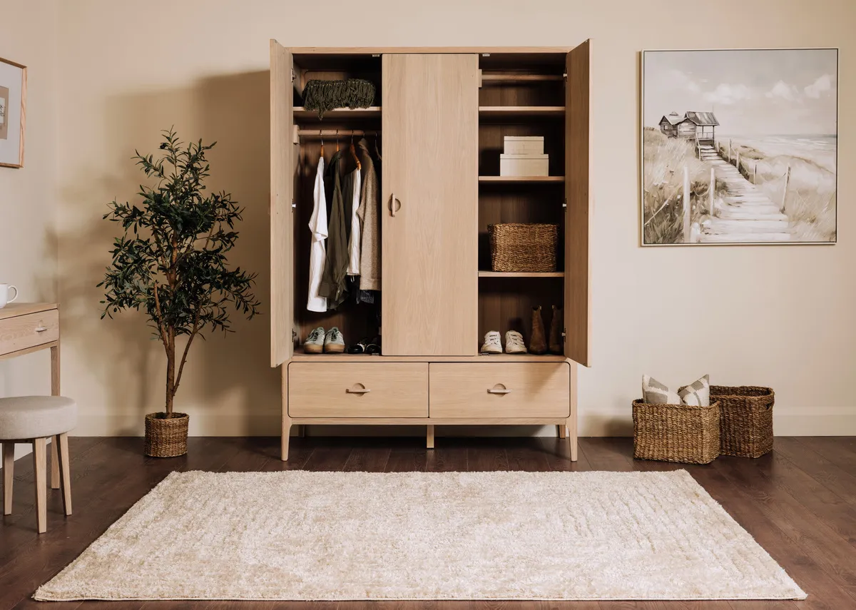 A lifestyle image of the Jay wardrobe with doors open and Jouney canvas.
