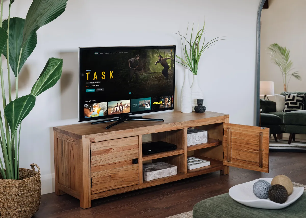A lifestyle image of the outback tv unit with Scarlet deco boxes inside and plant.