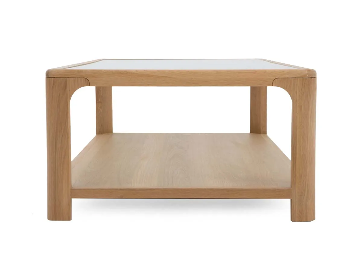 An oak coffee table with glass top and lower shelf from EZ Livings Gus range. Side view of thick frame
