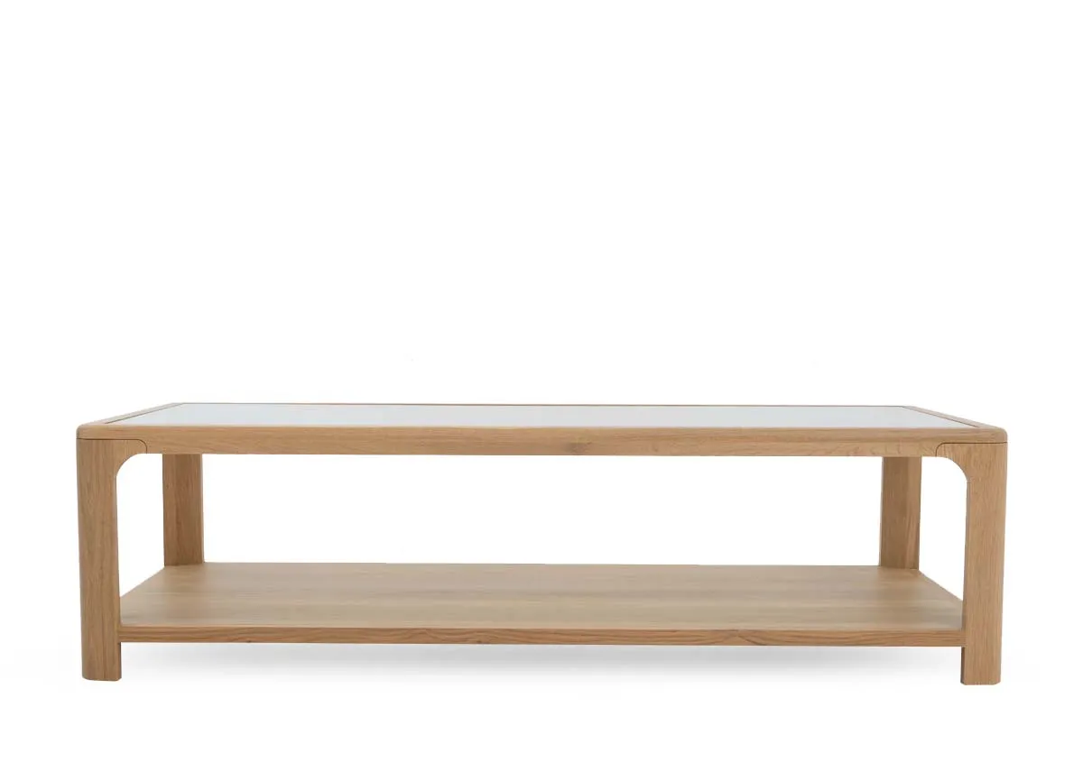 An oak coffee table with glass top and lower shelf from EZ Livings Gus range. Front view of ample shelf space
