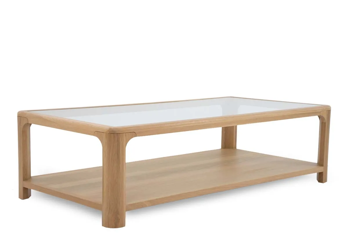 An oak coffee table with glass top and lower shelf from EZ Livings Gus range. Angled view.