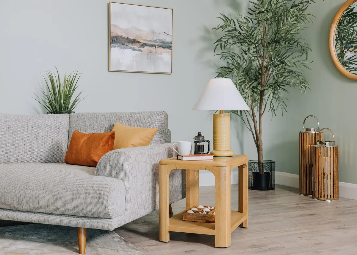 A lifestyle image of the Gus Oak lamp table with Althea Lamp