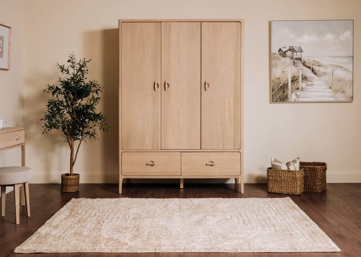 A lifestyle image of the Cadence rug with the Jay wardrobe