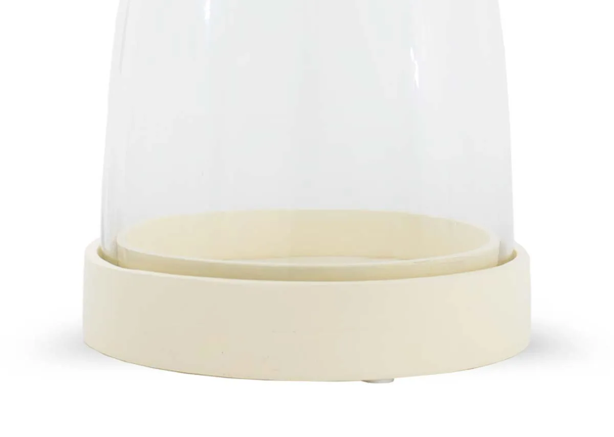 A closeup of the cream base with glass Carnationa holder for candle .