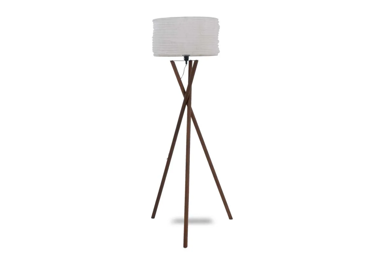 A wooden tripod floor lamp with white barrel shade. Front view.