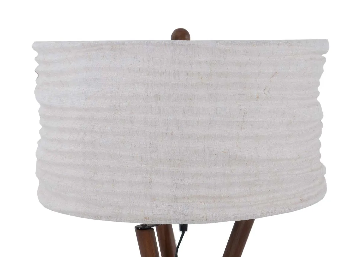 A wooden tripod floor lamp with white barrel shade.Closeup of white shade.