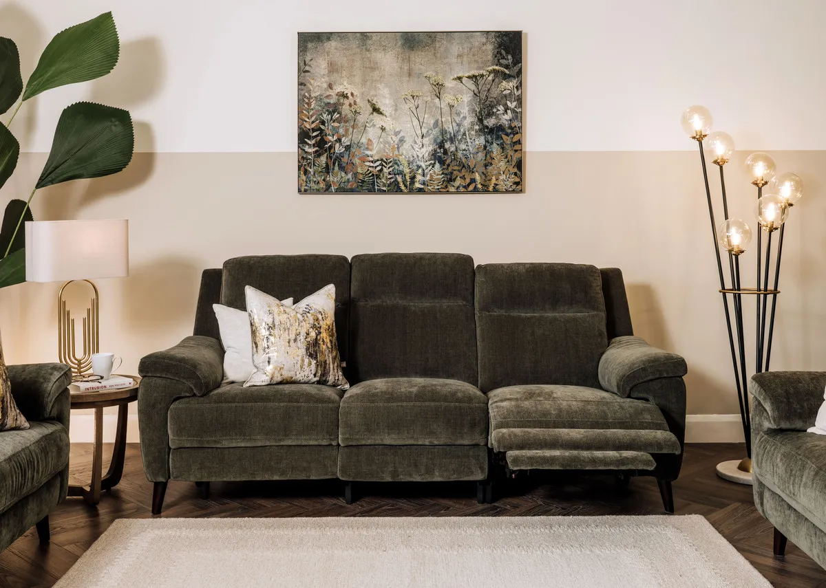 A 3 seater green fabric power reclining sofa from EZ Livings Elliot range. Angled view of sofa reclined