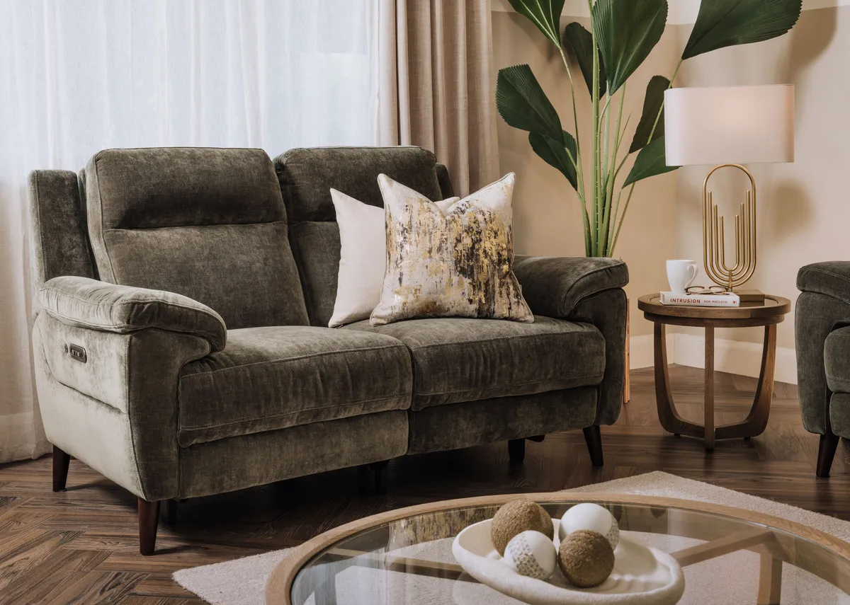A lifestyle image of the Elliot green 2 seater sofa with Alexis tables