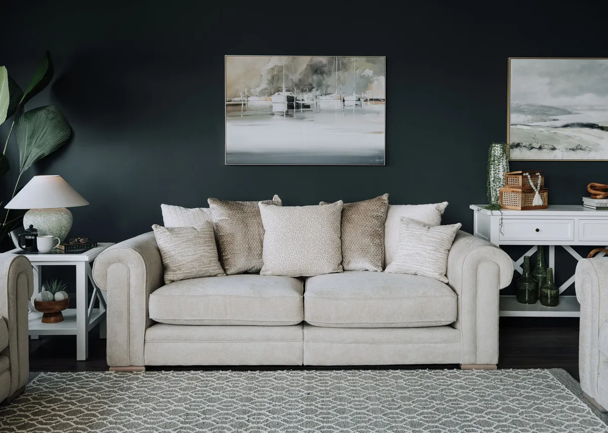 A lifestyle image of the Olivia PB sofa with Hampton side table and lee table lamp.