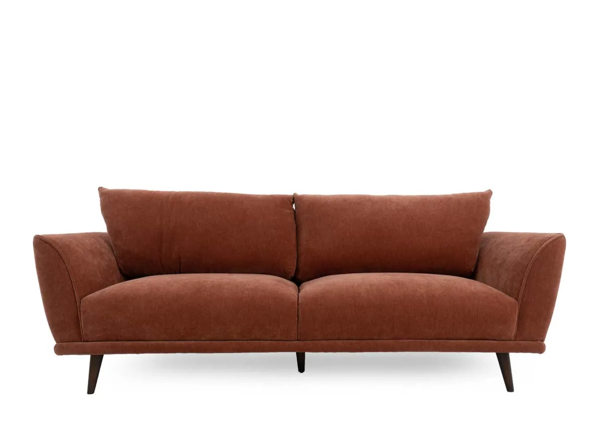 Four seater sofa in rust colored fabric presented from a straight on front view with two seat and two back cushions.