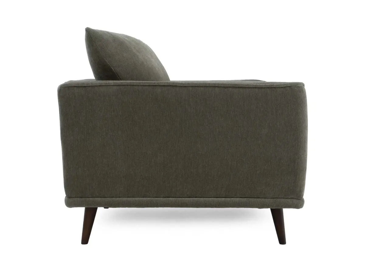 Cuddler armchair in olive green fabric showing the side profile with the armrest and flared back cushion.