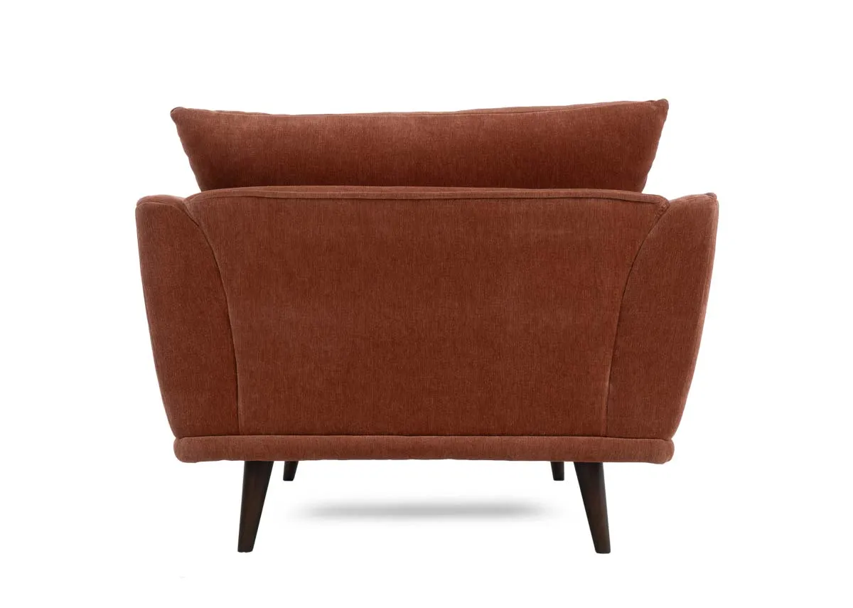 Cuddler armchair in rust colored fabric showing the back and a single back cushion.