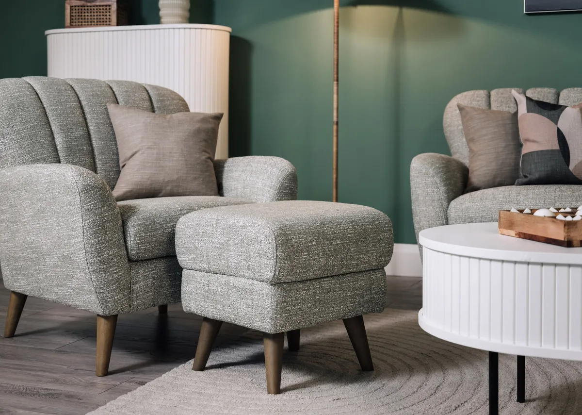 A lifestyle image of the Harper footstool with matching armchair and Nola white coffe table.