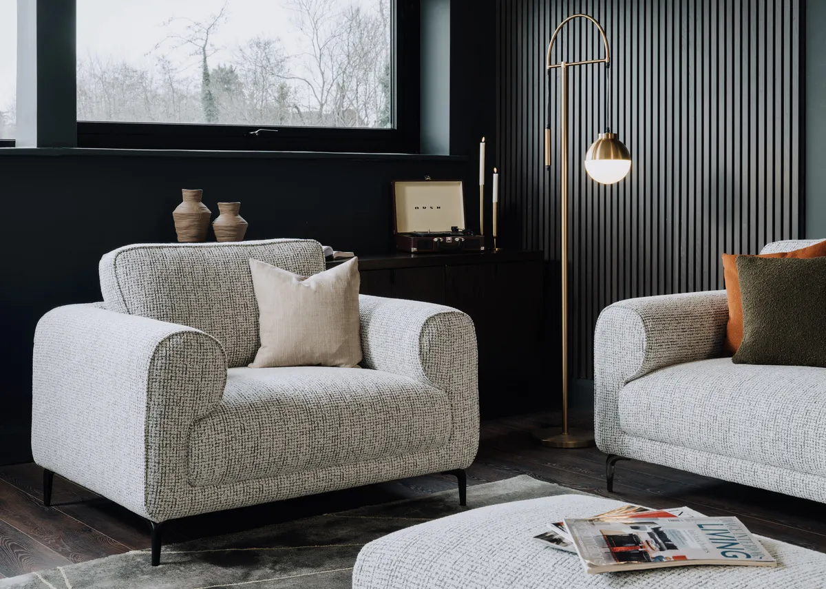 A lifestyle image of the Oyster armchair with the Casper floor lamp and avery rug.
