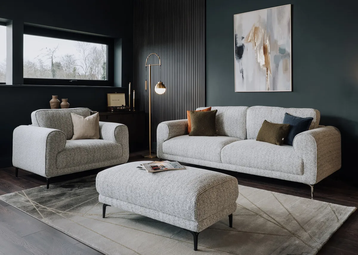 A lifestyle image of the Oyster Footstool with the matching sofas with Avery rug and Inspired canvas.