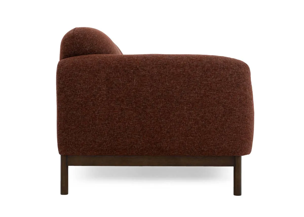A 2 seater sofa in brick rust fabric from EZ Livings Loft range. Side view of long low armrests.