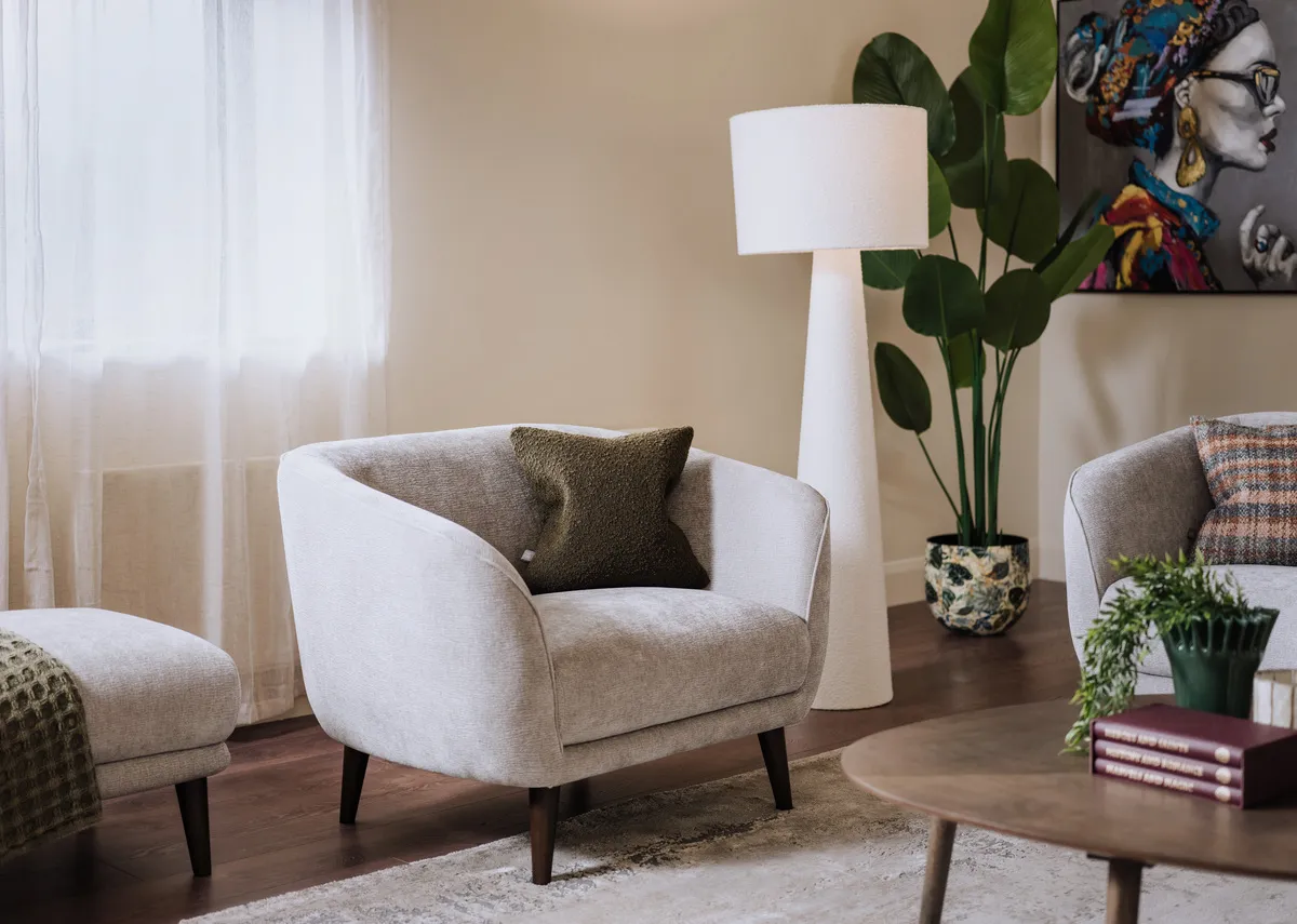 A lifetsyle image of the Amber silver armchair with Tolka lamp and Contessa picture.