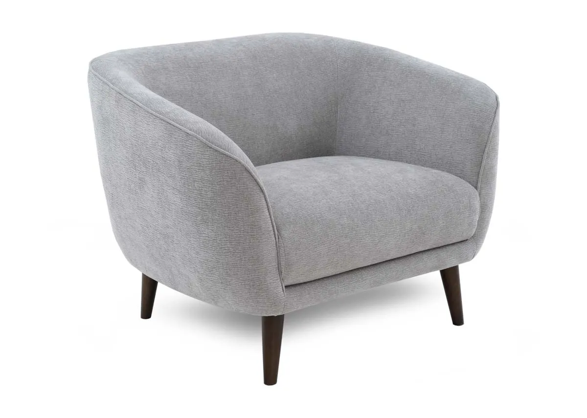 A silver armchair from EZ Livings Amber range. Angled view of rounded back.