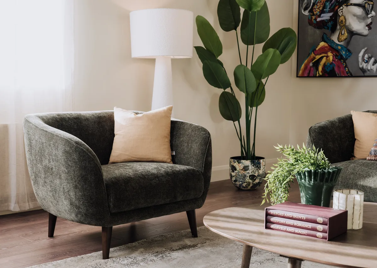 A lifestyle image of the Amber green armchair with sonoma tables and Tolka floor lamp with Contessa print.