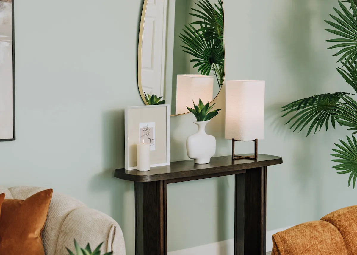 A lifestyle image of the Natu console table with Myla frame and Wyn table lamp.