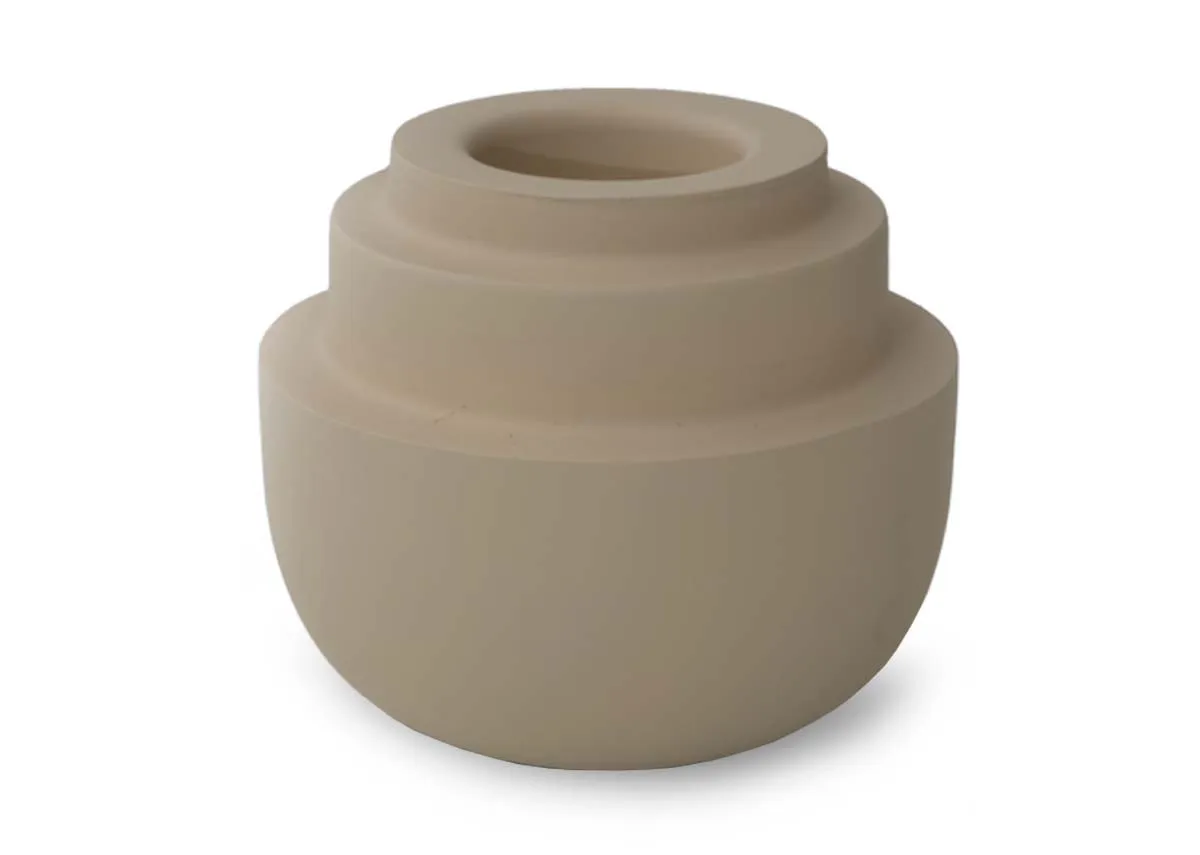 A small matt cream tealight holder with a rounded base and three concentric tiered sections on top shown from the front.