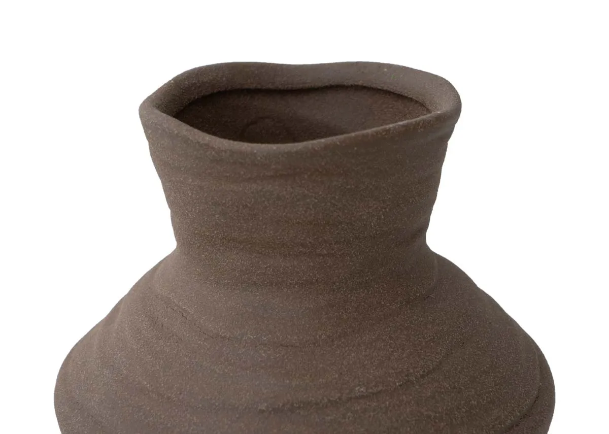A brown textured vase from EZ Livings Greccio vase. Closeup of handmade vase