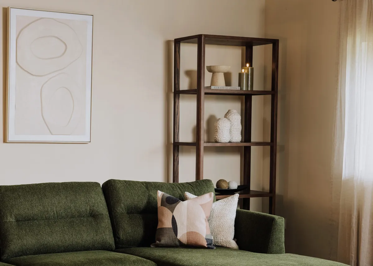 A lifestyle image of the Flow espresso bookcase with a selection of vases including the Asola.
