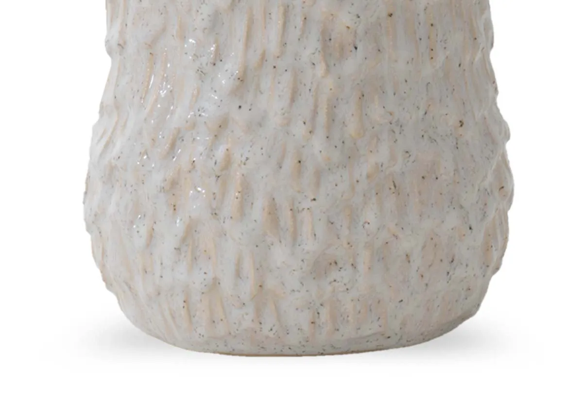 A close up of the textured wave like surface of a large brown decorative item.