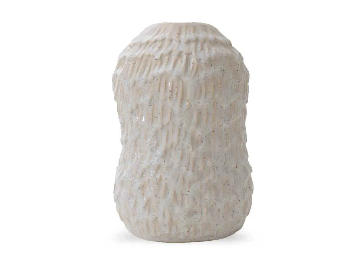 A large brown colored decorative item with a textured wave like surface and a ruffled opening.