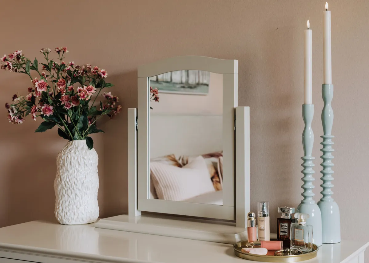 A lifestyle image of the Ridge blue candleholders with Asola large vase on a dressing table